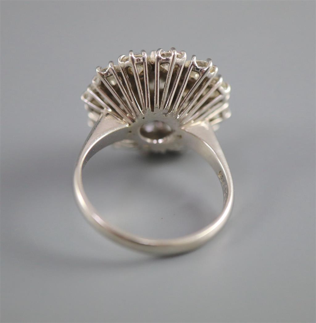 A modern 14ct white gold and diamond cluster ring,